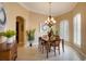 Traditional dining room boasting a chandelier and plantation shutters for an elegant touch at 128 Hallstrom Ct, Debary, FL 32713