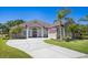 Charming single-Gathering home featuring a concrete driveway and well-manicured landscaping at 128 Hallstrom Ct, Debary, FL 32713