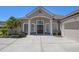 Lovely single-Gathering home showcasing manicured landscaping and a concrete driveway at 128 Hallstrom Ct, Debary, FL 32713