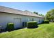Exterior of the home with a side-entry garage, mature landscaping, and a well-manicured lawn at 128 Hallstrom Ct, Debary, FL 32713