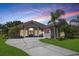 Stunning single-story home with lush landscaping, a wide driveway, and a charming front porch at 128 Hallstrom Ct, Debary, FL 32713