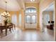 Inviting foyer featuring decorative front doors and clear views into the office and dining room at 128 Hallstrom Ct, Debary, FL 32713