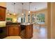 Open kitchen with island, stainless appliances, granite countertops, and adjacent breakfast nook overlooking pool at 128 Hallstrom Ct, Debary, FL 32713