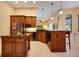Open kitchen with island, custom cabinets, granite countertops, and breakfast bar, perfect for gatherings at 128 Hallstrom Ct, Debary, FL 32713