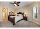 This main bedroom offers a ceiling fan, neutral walls, carpet and a window with shutters at 128 Hallstrom Ct, Debary, FL 32713