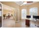 A home office featuring tile flooring and large windows with plantation shutters next to an open dining room at 128 Hallstrom Ct, Debary, FL 32713