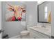 Stylish powder room featuring white vanity and unique art at 129 S Park Ave # 129, Winter Garden, FL 34787
