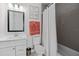 A well-lit bathroom showcases modern fixtures, gray tile accents, and a clean, fresh aesthetic at 129 S Park Ave # 129, Winter Garden, FL 34787