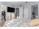 Bedroom features a television, neutral paint, closet, and bath access at 129 S Park Ave # 129, Winter Garden, FL 34787