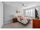Cozy bedroom with a comfortable bed, neutral colors, a ceiling fan, and a sun-filled window at 129 S Park Ave # 129, Winter Garden, FL 34787