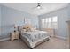 Inviting bedroom featuring a bed with floral quilt, side tables, and a dresser at 129 S Park Ave # 129, Winter Garden, FL 34787
