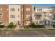Charming townhome exterior featuring red brick, manicured landscaping, and inviting entryways under a clear sky at 129 S Park Ave # 129, Winter Garden, FL 34787