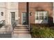 Two-story brick townhome featuring a covered entry, multi-pane windows, and professional landscaping at 129 S Park Ave # 129, Winter Garden, FL 34787