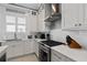 Modern kitchen features white cabinets, quartz countertops, and stainless steel appliances at 129 S Park Ave # 129, Winter Garden, FL 34787
