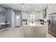Bright kitchen with an island, white cabinetry, and stainless steel appliances, perfect for cooking and entertaining at 129 S Park Ave # 129, Winter Garden, FL 34787