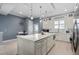 A gourmet kitchen features an expansive center island with white countertops and modern stainless steel appliances at 129 S Park Ave # 129, Winter Garden, FL 34787