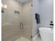 Modern shower with glass door, neutral tile, and built-in niche and fixtures at 129 S Park Ave # 129, Winter Garden, FL 34787
