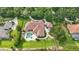 Overhead view showcasing a private pool, landscaped yard, attached garage, and an expansive driveway at 13025 Water Point Blvd, Windermere, FL 34786
