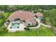 Magnificent property with a backyard oasis showcasing a sparkling pool, elegant patio, and well-manicured lawn at 13025 Water Point Blvd, Windermere, FL 34786