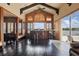 Vaulted ceiling bar with brick accents, dark wood floors, and views of the outdoor landscape at 13025 Water Point Blvd, Windermere, FL 34786