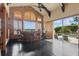 Bar area featuring brick accents, dark wood floors, and an open view to the pool at 13025 Water Point Blvd, Windermere, FL 34786