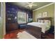 Comfortable bedroom featuring a built-in bookcase, hardwood floors and a ceiling fan at 13025 Water Point Blvd, Windermere, FL 34786