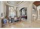 Formal dining room features tile floors, elegant chandelier, and neutral decor at 13025 Water Point Blvd, Windermere, FL 34786