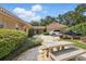 Long driveway with view of rear entry garage, covered entry, and stone picnic table at 13025 Water Point Blvd, Windermere, FL 34786