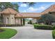 Expansive driveway with lush landscaping leads to a beautiful home near a serene lake at 13025 Water Point Blvd, Windermere, FL 34786