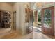 Home's entry features an elegant glass front door, tile flooring, and a view of the office at 13025 Water Point Blvd, Windermere, FL 34786