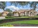 Stunning home exterior displays manicured landscaping, decorative shrubs, and a tiled roof at 13025 Water Point Blvd, Windermere, FL 34786