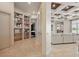 Bright hallway featuring built-in bookshelves and tile flooring leading to the living area at 13025 Water Point Blvd, Windermere, FL 34786
