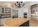 Gourmet kitchen with stainless refrigerator, dual ovens, and island seating at 13025 Water Point Blvd, Windermere, FL 34786