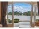 Breathtaking lake view from the home's interior, seamlessly blending indoor and outdoor living spaces at 13025 Water Point Blvd, Windermere, FL 34786
