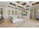Elegant living room featuring custom coffered ceiling, tile floors, and built-in entertainment center at 13025 Water Point Blvd, Windermere, FL 34786