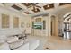Spacious living room with coffered ceiling, built-in shelving, and tile flooring at 13025 Water Point Blvd, Windermere, FL 34786