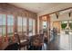 Brick accent office with wooden table and seating and an open-air view of the outside landscape at 13025 Water Point Blvd, Windermere, FL 34786