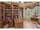 Classic office features built-in bookshelves, a desk, and an abundance of natural light at 13025 Water Point Blvd, Windermere, FL 34786