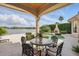 Lakeside patio with stone pavers, lounge chairs, outdoor fireplace, and a view of the lake at 13025 Water Point Blvd, Windermere, FL 34786