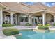 Lush landscaping surrounds pool of elegant home, perfect for entertaining or relaxing by the water at 13025 Water Point Blvd, Windermere, FL 34786