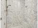 Modern marble shower featuring a built-in bench, rainfall shower-head and natural light at 13025 Water Point Blvd, Windermere, FL 34786