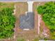 Aerial view of a home with a gray roof, surrounded by trees, and a long driveway at 13971 Sw 46Th Ter, Ocala, FL 34473