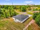 Aerial view of the house with gray roof, white exterior, and a patio area at 13971 Sw 46Th Ter, Ocala, FL 34473
