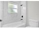 Modern bathroom with white tile and matte black hardware at 13971 Sw 46Th Ter, Ocala, FL 34473