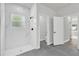 Bathroom with shower and large-format marble-look tile at 13971 Sw 46Th Ter, Ocala, FL 34473