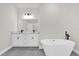 Bright bathroom with double sink vanity and freestanding tub at 13971 Sw 46Th Ter, Ocala, FL 34473