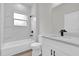 Modern bathroom featuring white vanity, quartz countertop, and tile shower with black fixtures at 13971 Sw 46Th Ter, Ocala, FL 34473