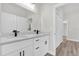 Bright bathroom featuring double sinks and light wood flooring at 13971 Sw 46Th Ter, Ocala, FL 34473