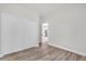 Bright bedroom with light-colored walls, wood-look floors, and a closet at 13971 Sw 46Th Ter, Ocala, FL 34473