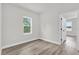 Bright bedroom with wood flooring and a window with treeline view at 13971 Sw 46Th Ter, Ocala, FL 34473